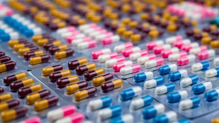 Selective focus on colorful antibiotic capsule pills in blister pack. Antibiotic drug resistance. Pharmaceutical industry. Pharmacy drug store backgro