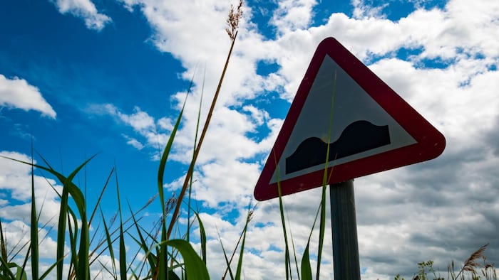 Road sign warning of bumps ahead