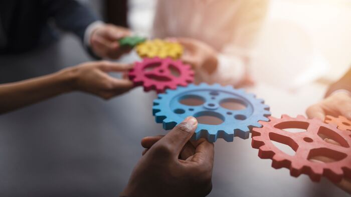 Business team connecting pieces of gears.