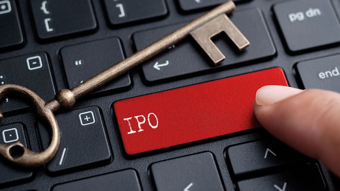 Closed up finger on keyboard with word IPO