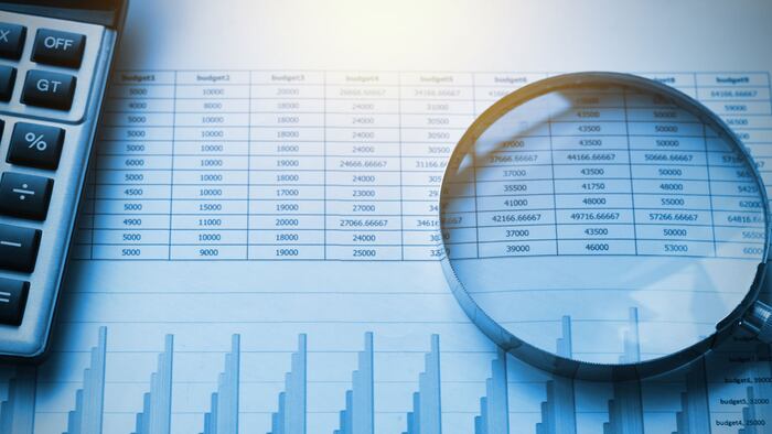 business documents accounting with calculator and magnifying glass. concept for financial