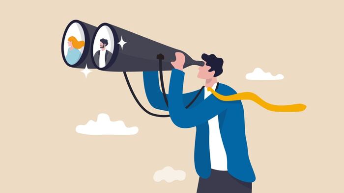 Man with binoculars searching for executives