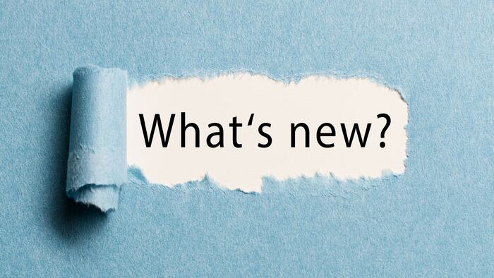 torn paper revealing the phrase "what's new?"