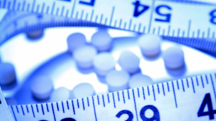 Weight-loss-pills-tape-measure_3113223_1200x675