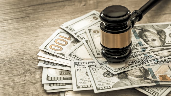 wooden gavel with usa dollar on desk. close up. toned image