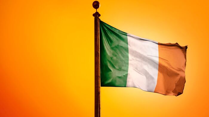 Irish flag flying against orange background