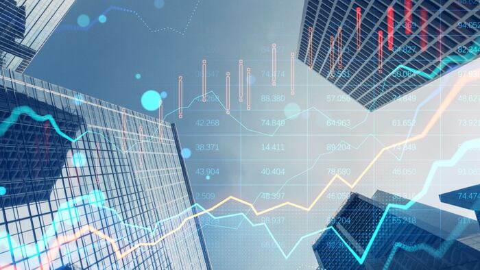 Multiple stock graphs and numerical data overlaid on a cityscape, representing the finance and economy