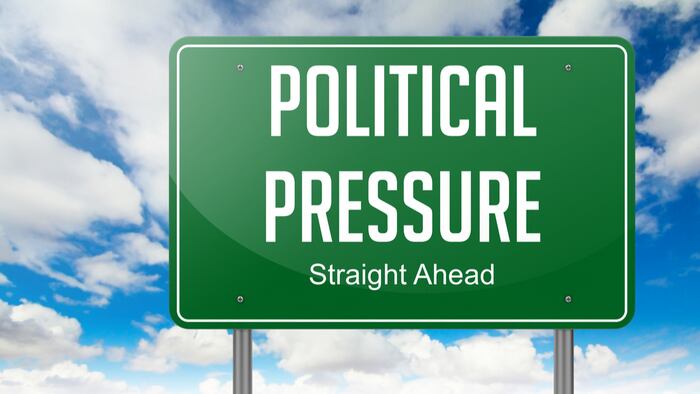 Highway Signpost with Political Pressure wording on Sky Background.