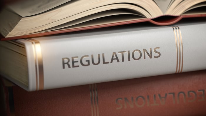 A stack of legal books with "Regulations" on the spines.