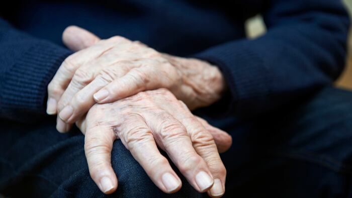 Close Up Of Senior Man Suffering With Parkinsons Diesease