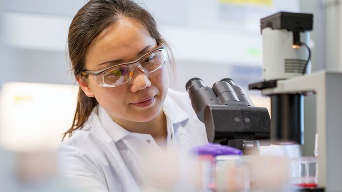 female scientist working with microscope