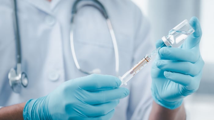 person getting ready to give a vaccine
