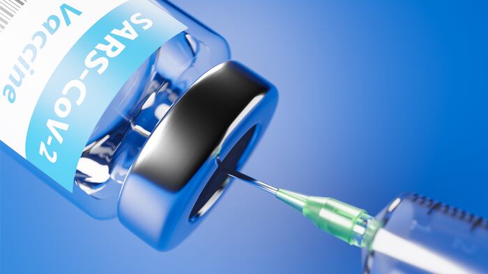 Vaccination against the new Corona Virus SARS-CoV-2: A syringe being drawn up with SARS-CoV-2 vaccination.