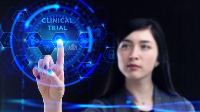 Young businessman working on a virtual screen of the future and sees the inscription: Clinical trial