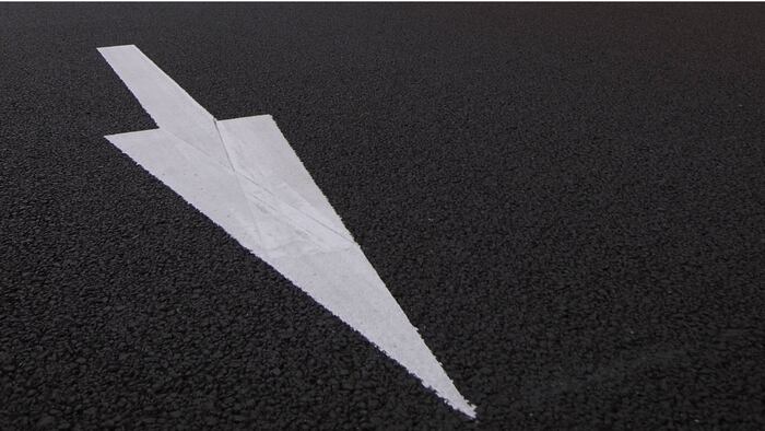 Down arrow on pavement