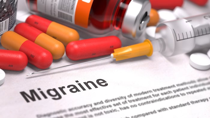 Diagnosis - Migraine. Medical Concept with Red Pills, Injections and Syringe. Selective Focus. 3D Render.