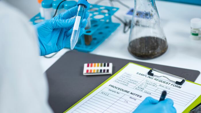 Organic agricultural product quality testing in certified laboratory. Scientist measuring pH of the sample with pH meter