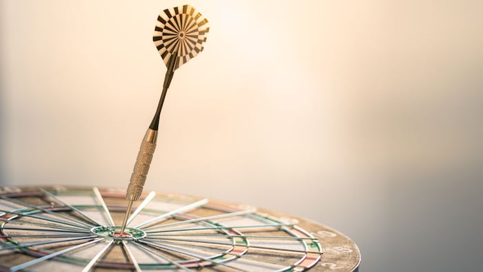Dart arrow hitting in the target center of dartboard using as background Target business, achieve and victory,success concept.