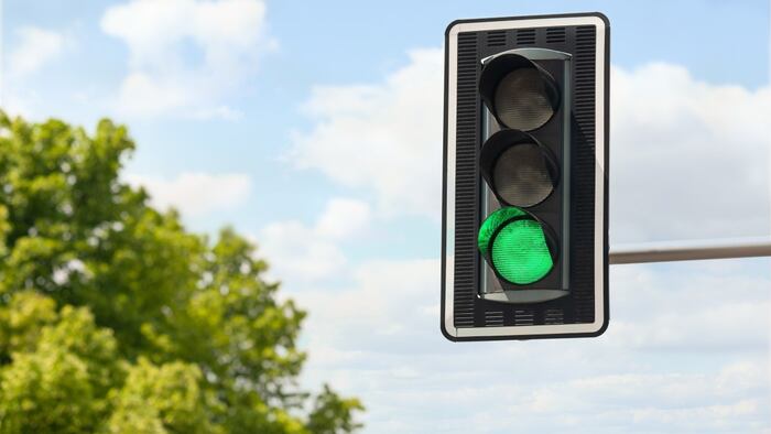 Traffic light against blue sky