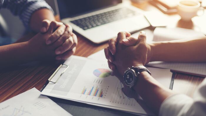 Two men negotiate deal terms