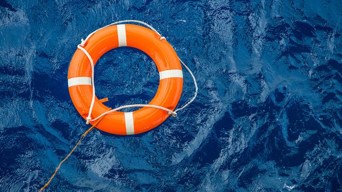 Safety equipment, Life buoy or rescue buoy floating on sea to rescue people from drowning man.