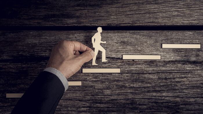 Promotion career advancement stairs wooden man