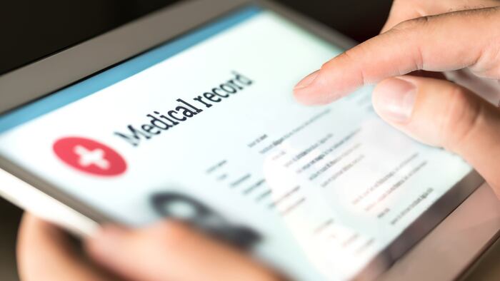 Electronic medical record with patient data and health care information in tablet.