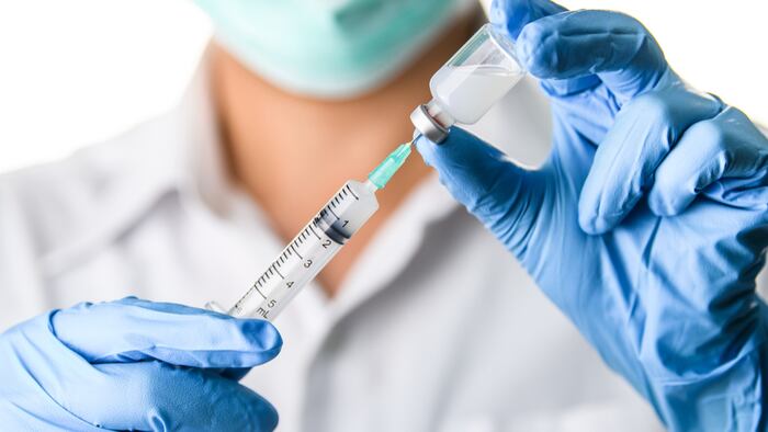 Doctor, nurse, scientist hand in blue gloves holding flu, measles, coronavirus, covid-19 vaccine disease preparing for child, baby, adult, man and woman vaccination shot, medicine and drug concept.