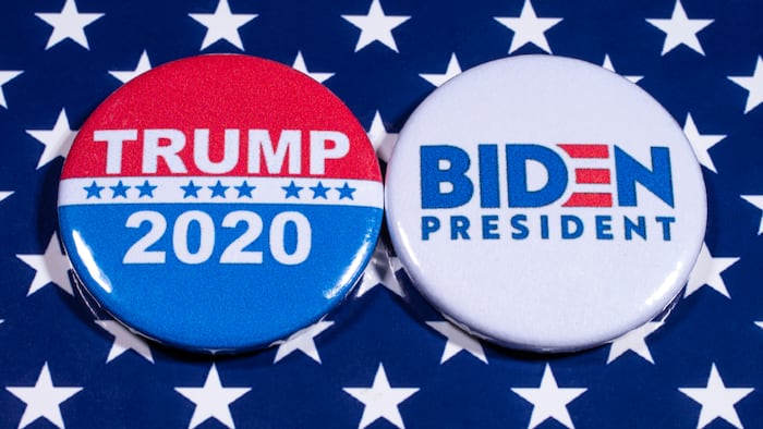 London, UK - May 5th 2020: Donald Trump and Joe Biden pin badges, pictured of the USA flag. The two men will be battling eachother in the 2020 US Presidential Election.