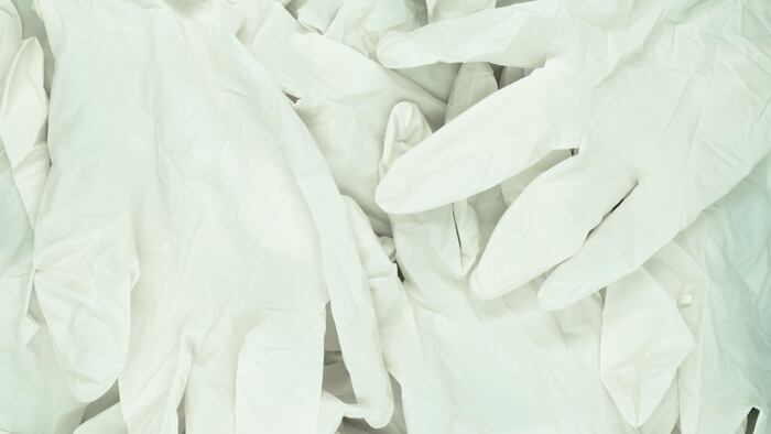 Large amount of white latex gloves background surface.