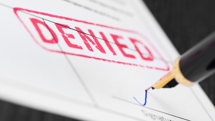 Denied red stamp with pen signature