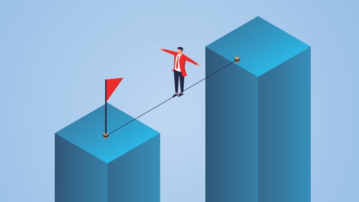 Man walking a tightrope between two buildings