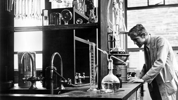 Scientist conducting a laboratory experiment in a cancer research facility in the United States, 1951.