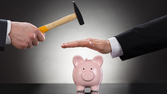 Man with hammer stopped from smashing a piggy bank