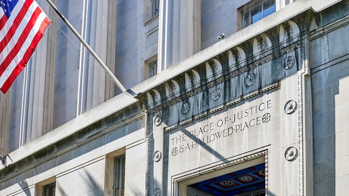 Washington DC, USA-June 5, 2018: Robert F Kennedy Department of Justice building entrance "The Place of Justice is a Hallowed Place" engraved in stone above the door
