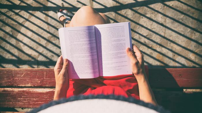 Top view of a woman reading a book. - Image