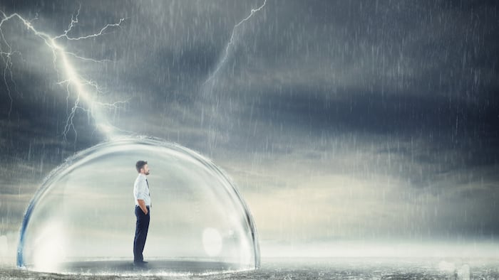 Businessman protected from the crisis in globe