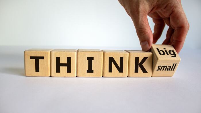 woodenblocks that say "think" and a block that has big on one face and small on the other face