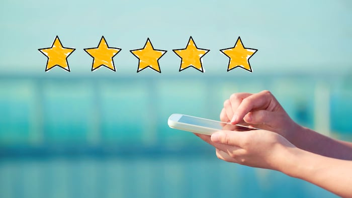 Five Star Rating with person holding a white smartphone - Image