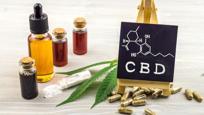 Full spectrum Cannabidiol CBD oils, capsules and crystals isolate with small blackboard with CBD word and chemical structure on wooden backdrop - Image