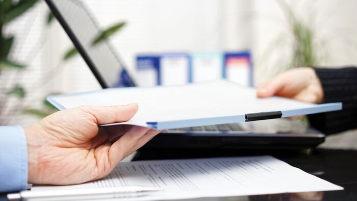 businessman and businesswoman are exchanging document or contract