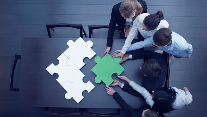 Group of business people assembling jigsaw puzzle, team support and help concept