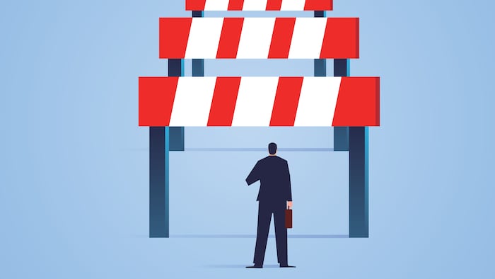 businessman standing in front of a row of railings