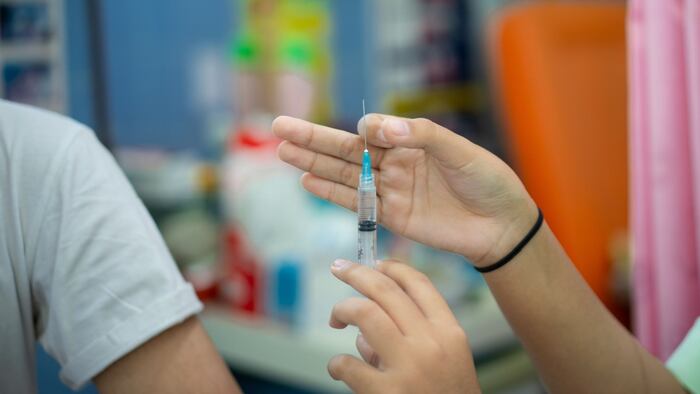 Close up of a Doctor making a vaccination in the shoulder of patient