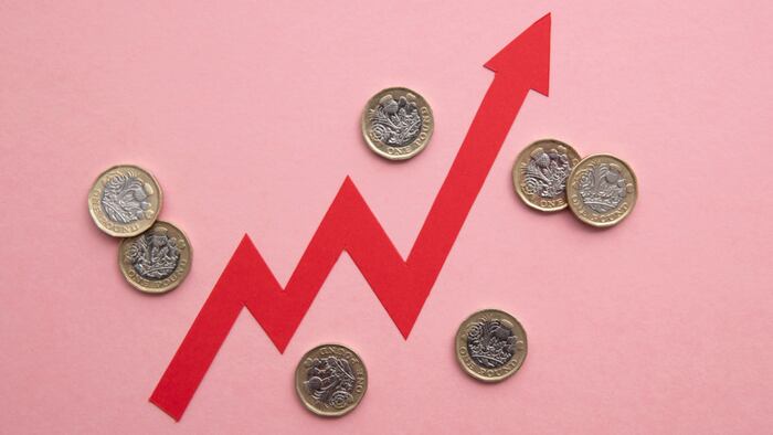 Jagged red arrow pointing upward surrounded by pound coins