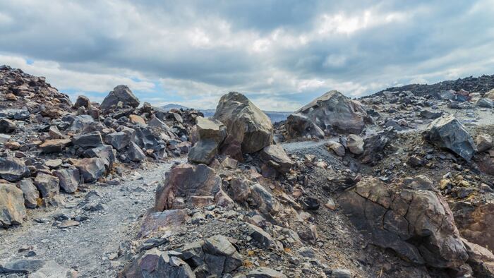 Exotic rocky road to the crater of the volcano in the famous Caldera of Santorini island