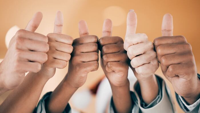 Six hands with thumbs up