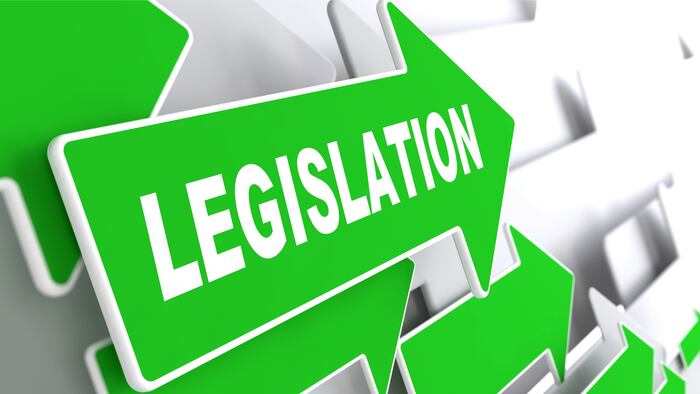 Legislation on Direction Sign - Green Arrow on a Grey Background.