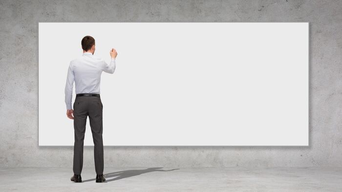 business, education and office people concept - businessman or teacher with marker writing or drawing something on white blank board over concrete wall background from back - Image