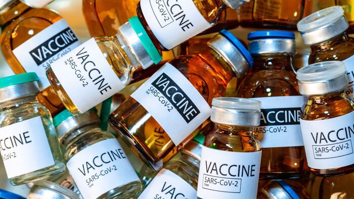 Vaccine vials of Sars-cov-2 on table in laboratory
